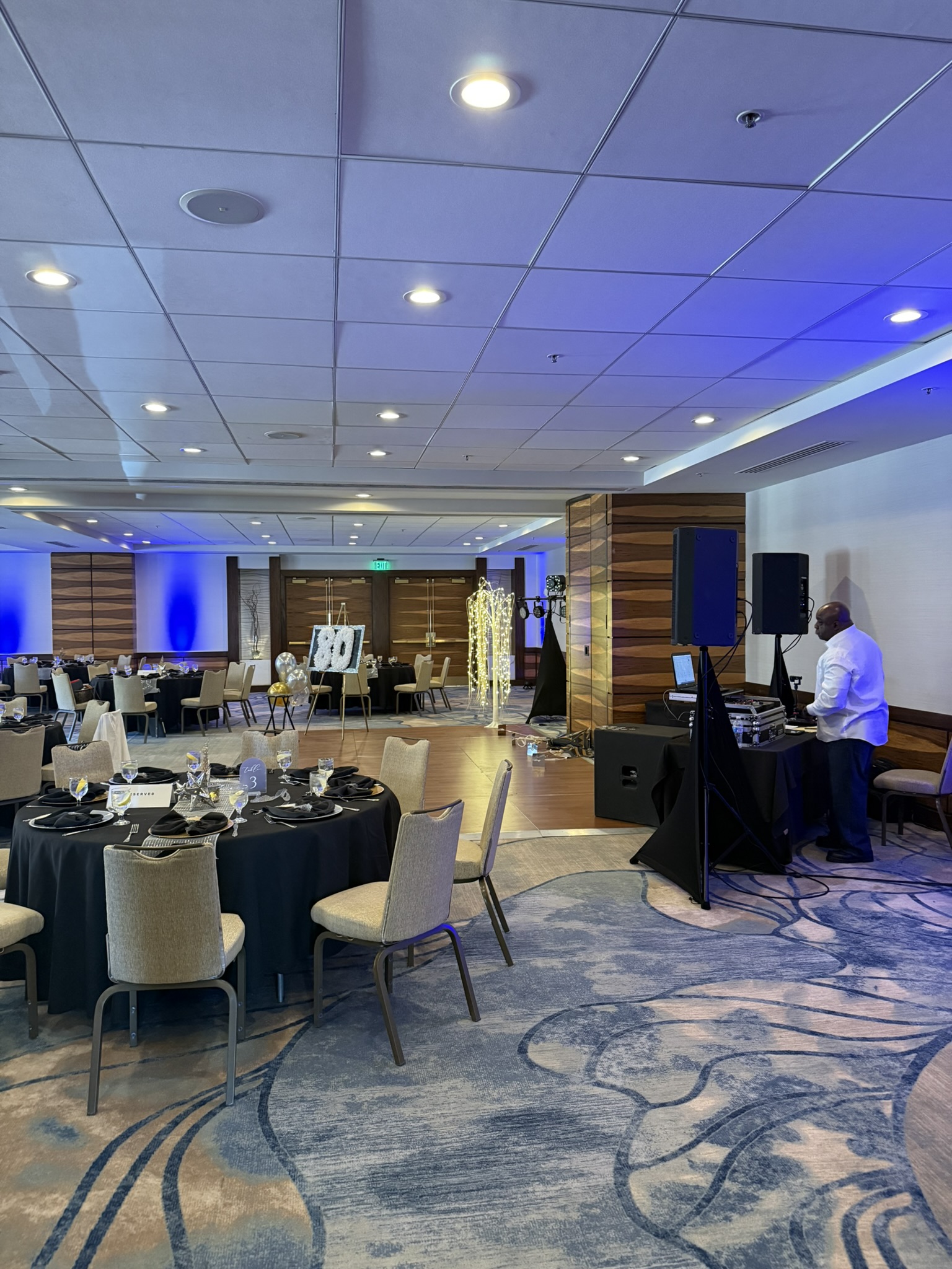 360 video booth set up in a hotel ballroom with blue uplighting