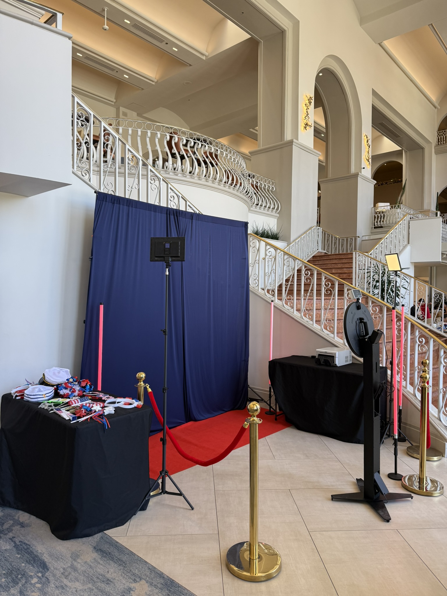 360 video booth with red carpet and stanchions in a hotel lobby
